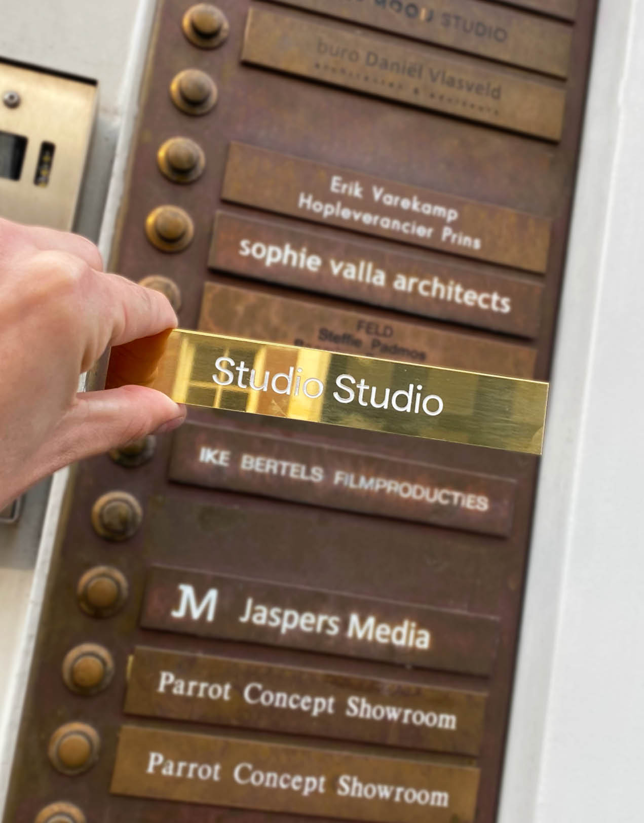 Photo of hand holding Studio Studio name tag